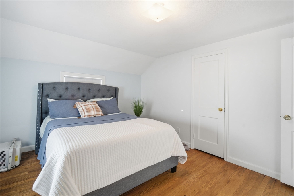 13 Bither Street Springfield, MA 01118 - Photo 20 of 29 a bedroom with a bed and a painting on the wall