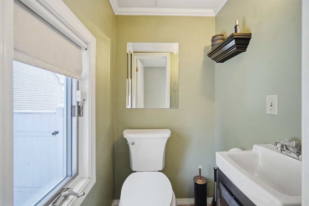 13 Bither Street Springfield, MA 01118 - Photo 23 of 29 a bathroom with a toilet a sink and mirror