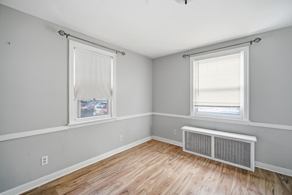 13 Bither Street Springfield, MA 01118 - Photo 24 of 29 a view of an empty room with wooden floor and a window