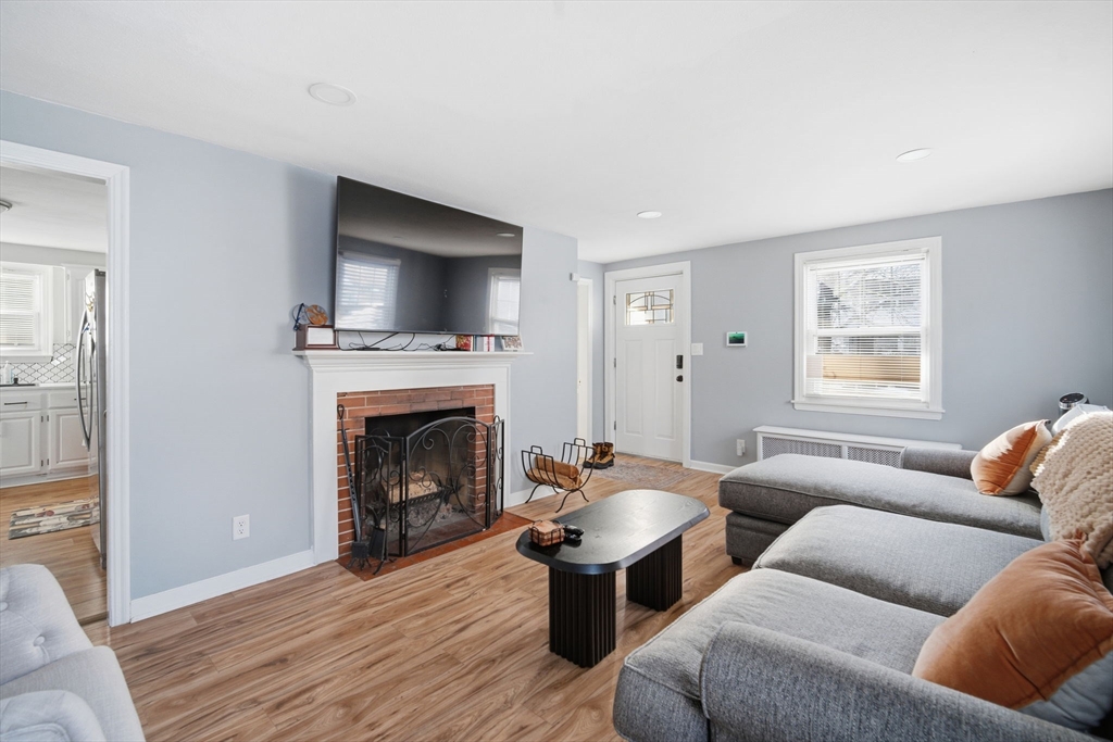 13 Bither Street Springfield, MA 01118 - Photo 7 of 29 a living room with furniture a window and a fireplace