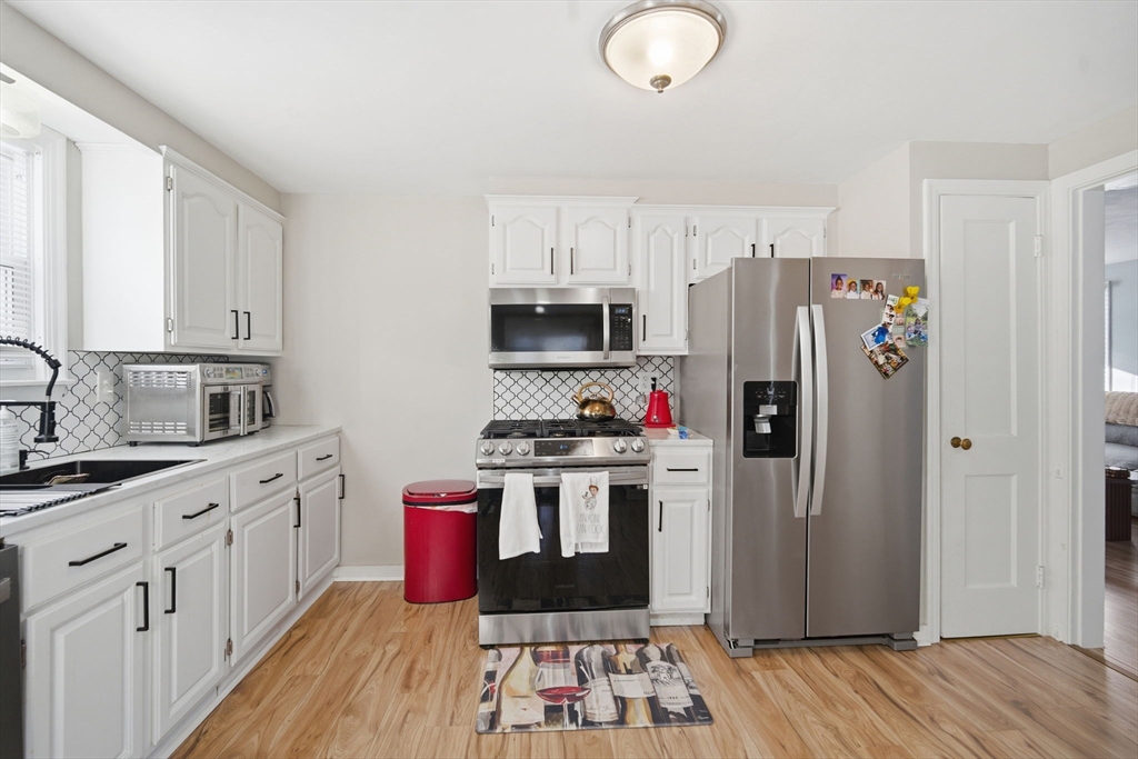 13 Bither Street Springfield, MA 01118 - Photo 10 of 29 a kitchen with stainless steel appliances a stove refrigerator and cabinets