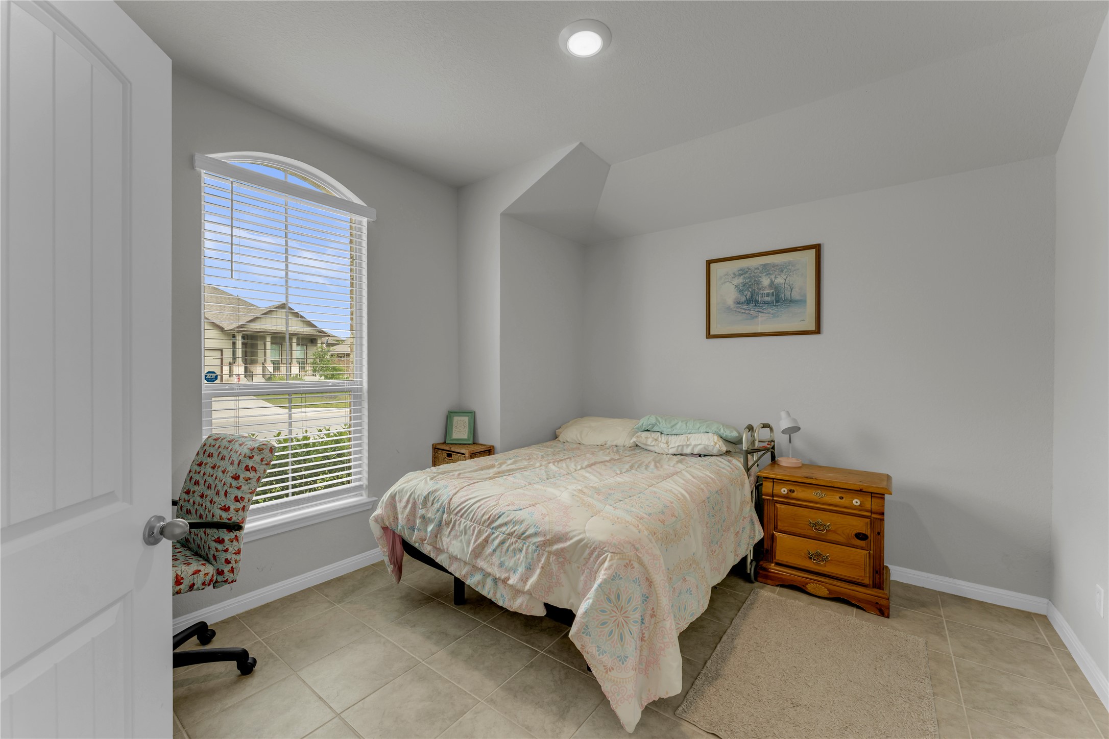 132 Cinnamon Loop Burnet, TX 78611 - Photo 15 of 27 Bright office or 5th bedroom featuring an arched window with blinds, tile flooring, and a recessed ceiling light