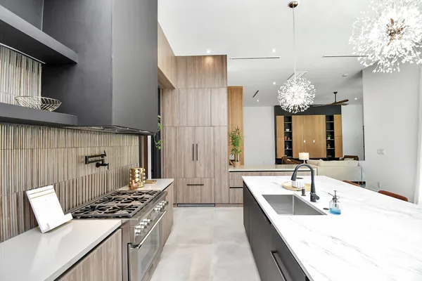 a kitchen with a sink appliances and a large window