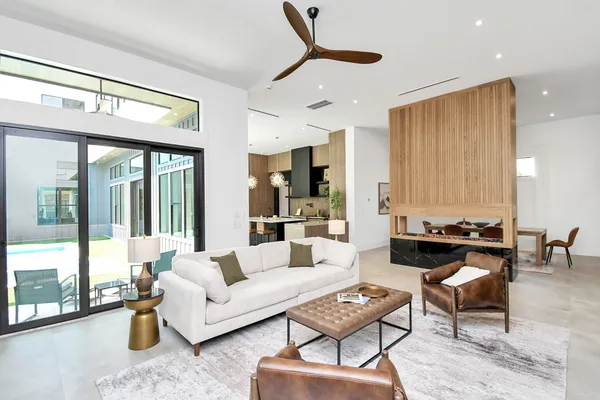 a living room with furniture and large window