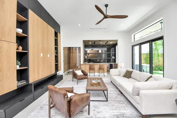 a view of a dining room with furniture and a kitchen