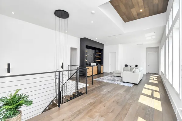 a view of hallway with stairs and wooden floor