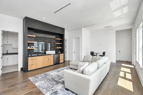 a living room with furniture and floor to ceiling windows