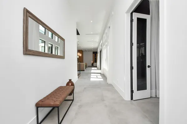 a view of a hallway and a livingroom with furniture