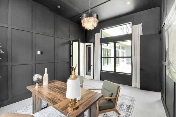 a view of a dining room with furniture and chandelier