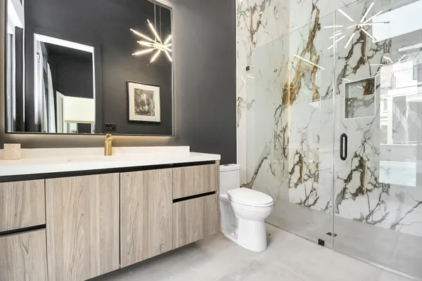 a bathroom with a sink toilet and a mirror