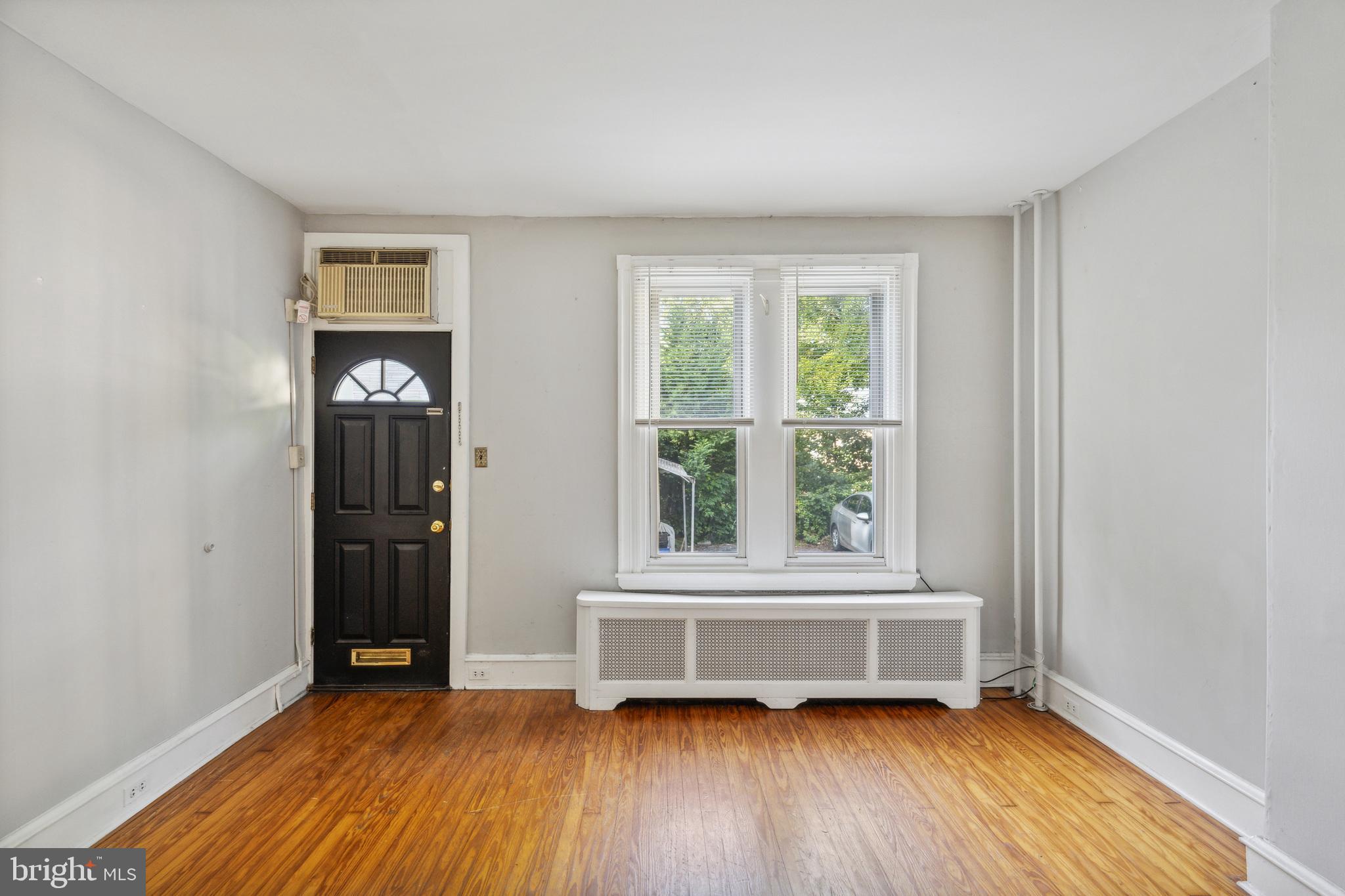 4483 Boone Street Philadelphia, PA 19128 - Photo 3 of 15 an empty room with wooden floor and windows