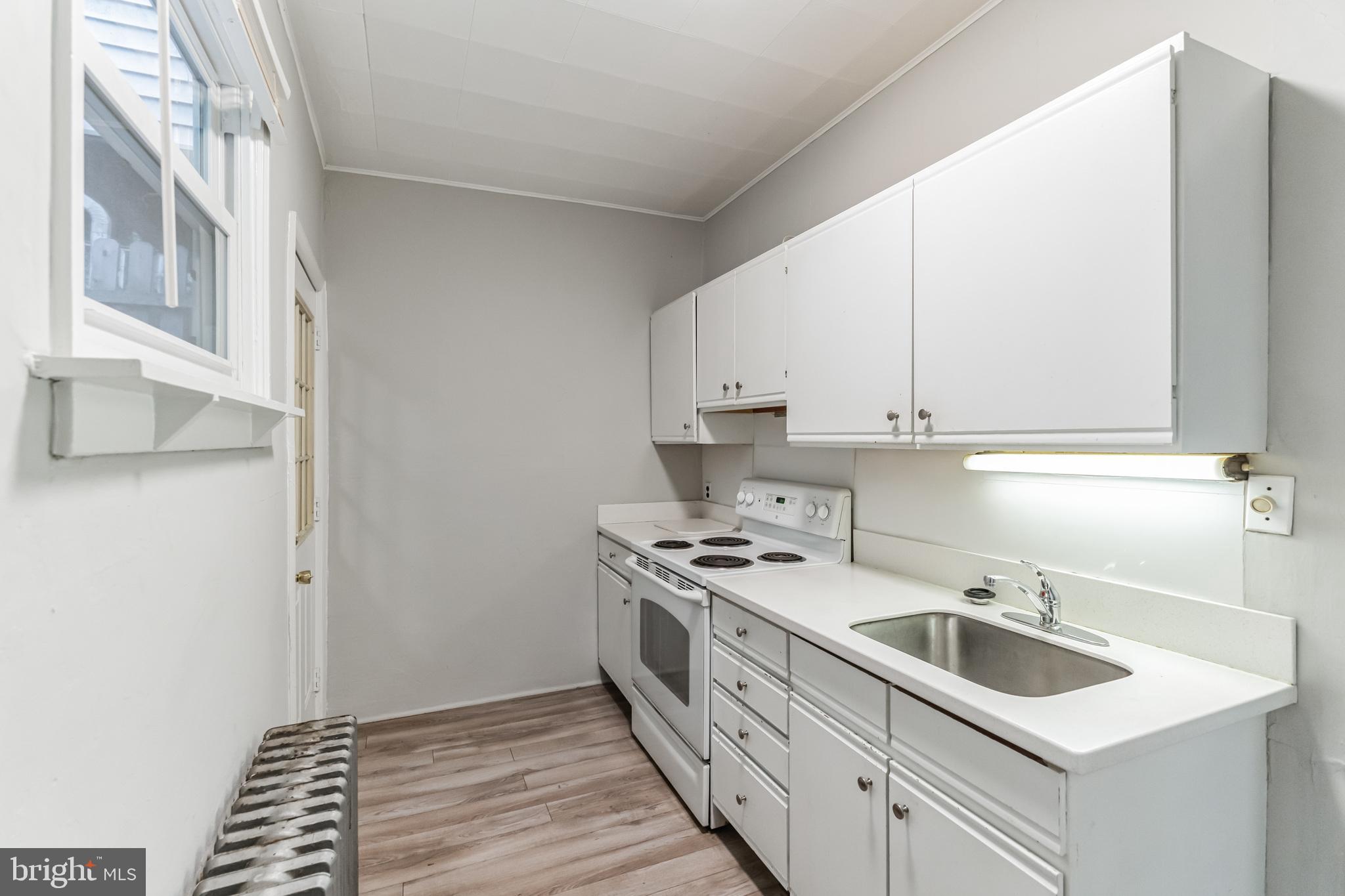 4483 Boone Street Philadelphia, PA 19128 - Photo 7 of 15 a kitchen that has a sink and a stove