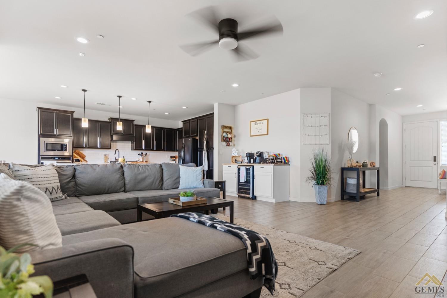 Undisclosed Address Bakersfield, CA 93314 - Photo 13 of 44 a living room with furniture and a view of kitchen