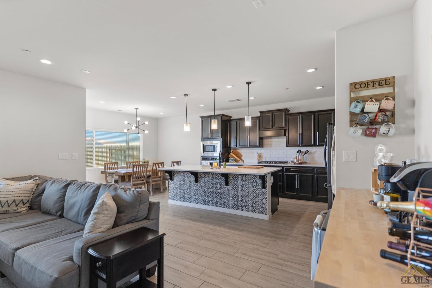 Undisclosed Address Bakersfield, CA 93314 - Photo 14 of 44 a living room with furniture kitchen area and a wooden floor
