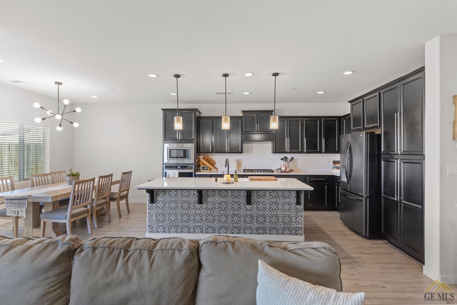 Undisclosed Address Bakersfield, CA 93314 - Photo 17 of 44 a large kitchen with kitchen island a sink stove and a refrigerator