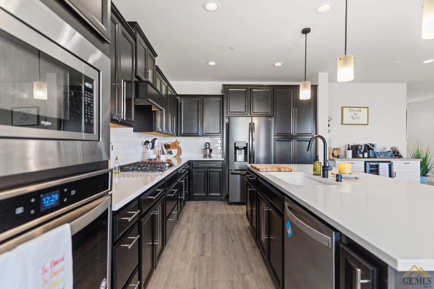 Undisclosed Address Bakersfield, CA 93314 - Photo 20 of 44 a kitchen with stainless steel appliances granite countertop a sink a stove and a refrigerator