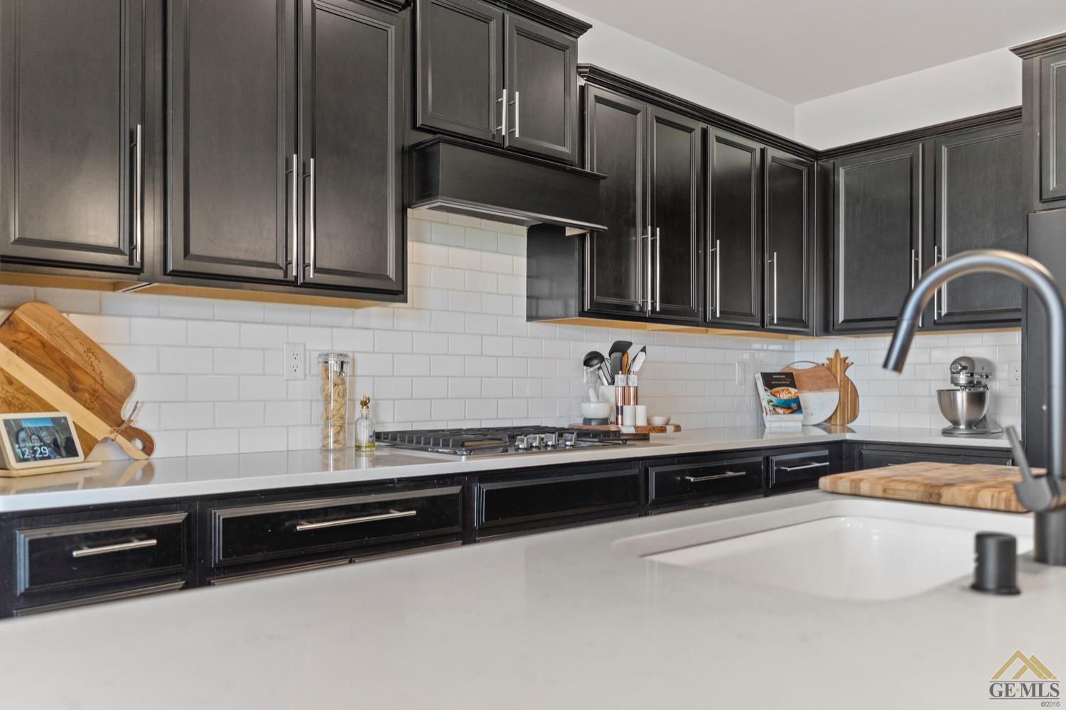 Undisclosed Address Bakersfield, CA 93314 - Photo 21 of 44 a kitchen with stainless steel appliances a sink stove and cabinets