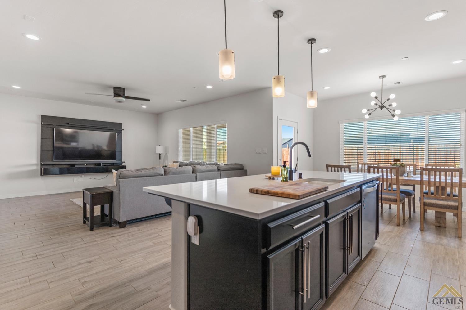 Undisclosed Address Bakersfield, CA 93314 - Photo 24 of 44 a kitchen with sink stove and wooden floor