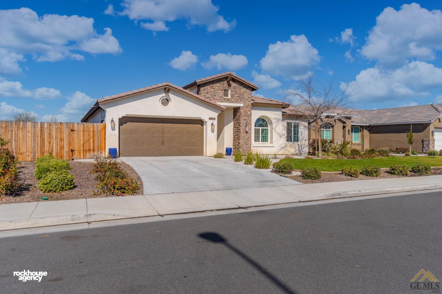 Undisclosed Address Bakersfield, CA 93314 - Photo 3 of 44 a front view of a house with a yard and garage