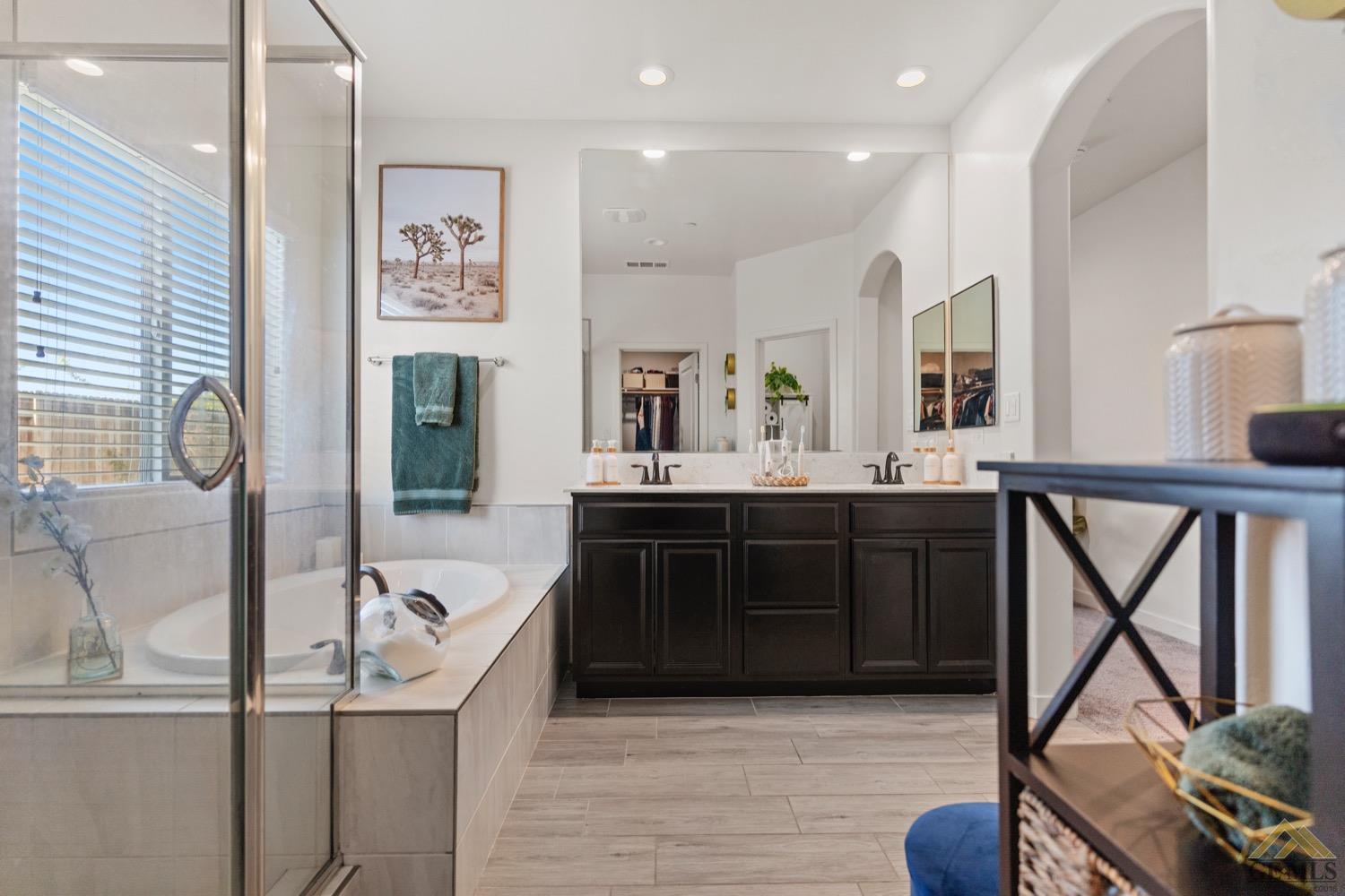 Undisclosed Address Bakersfield, CA 93314 - Photo 31 of 44 a spacious bathroom with a tub sink and mirror