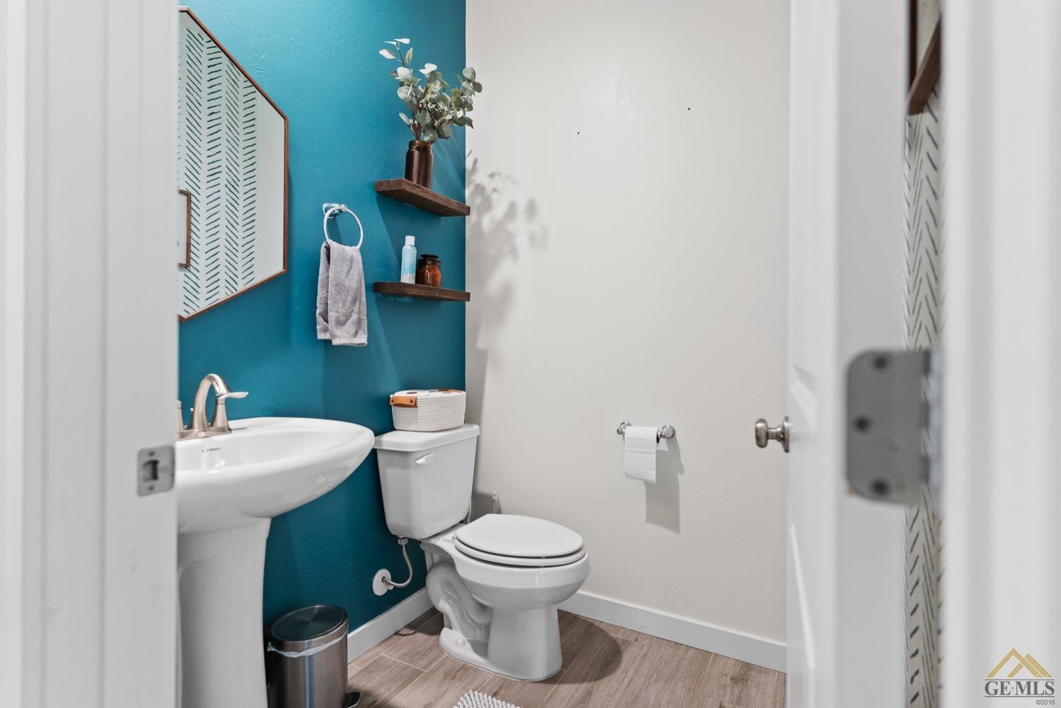 Undisclosed Address Bakersfield, CA 93314 - Photo 34 of 44 a bathroom with a toilet sink and mirror