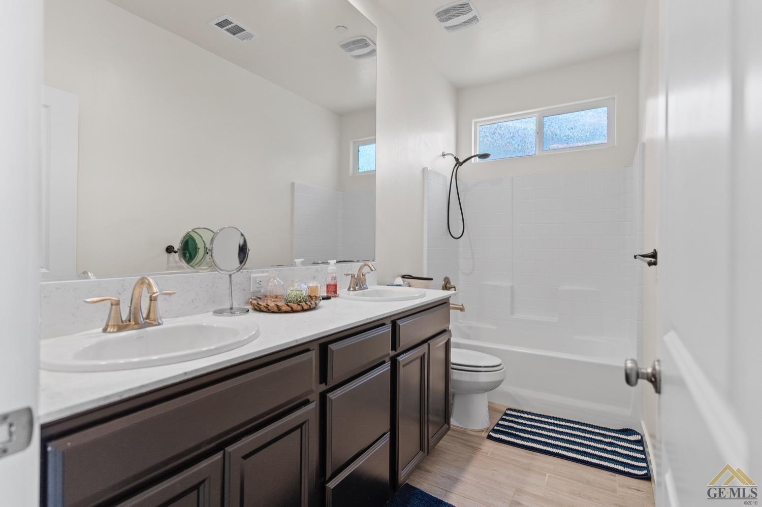 Undisclosed Address Bakersfield, CA 93314 - Photo 36 of 44 a bathroom with a sink a toilet and shower