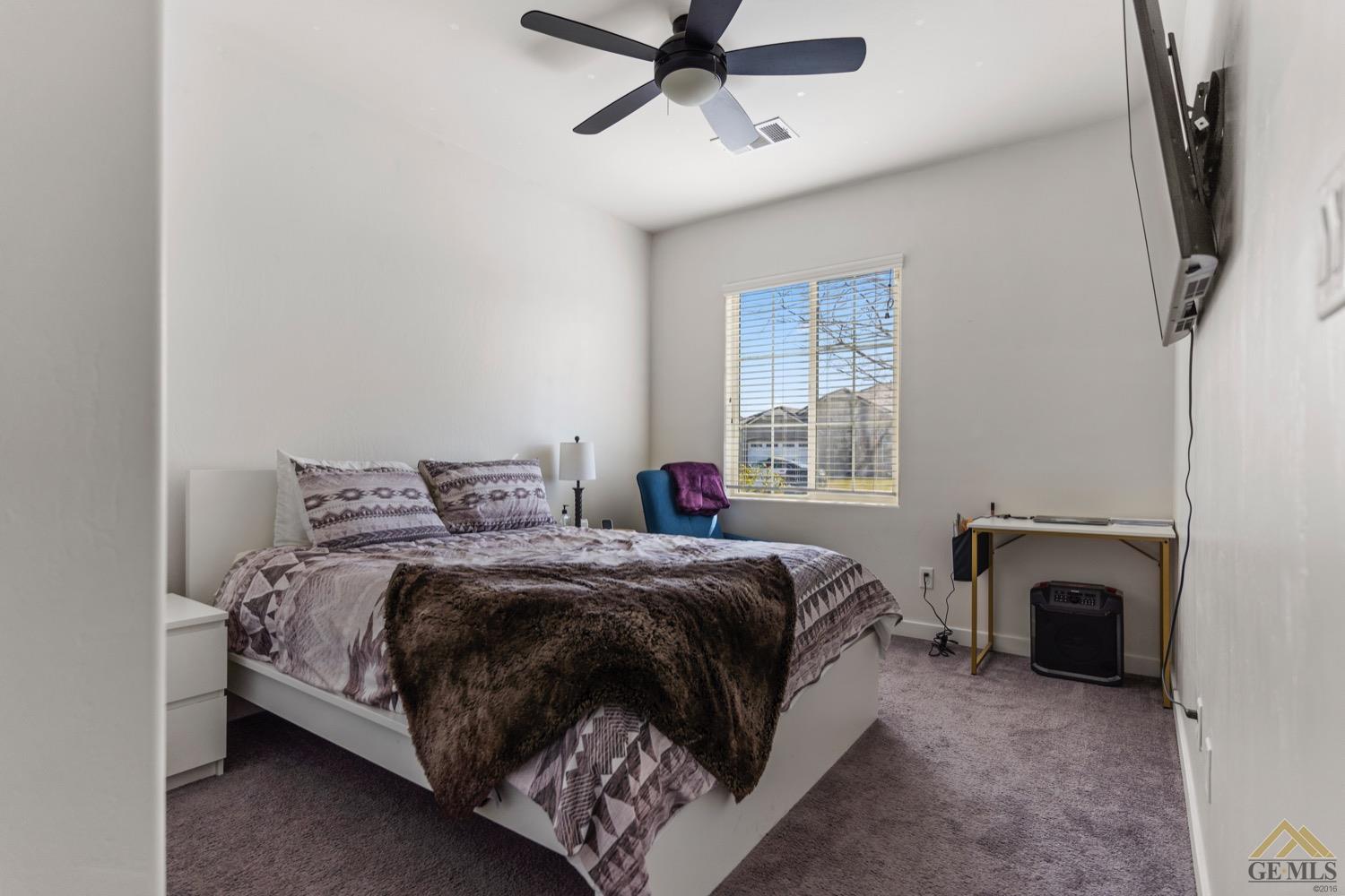 Undisclosed Address Bakersfield, CA 93314 - Photo 37 of 44 a bed room with a bed and a fireplace