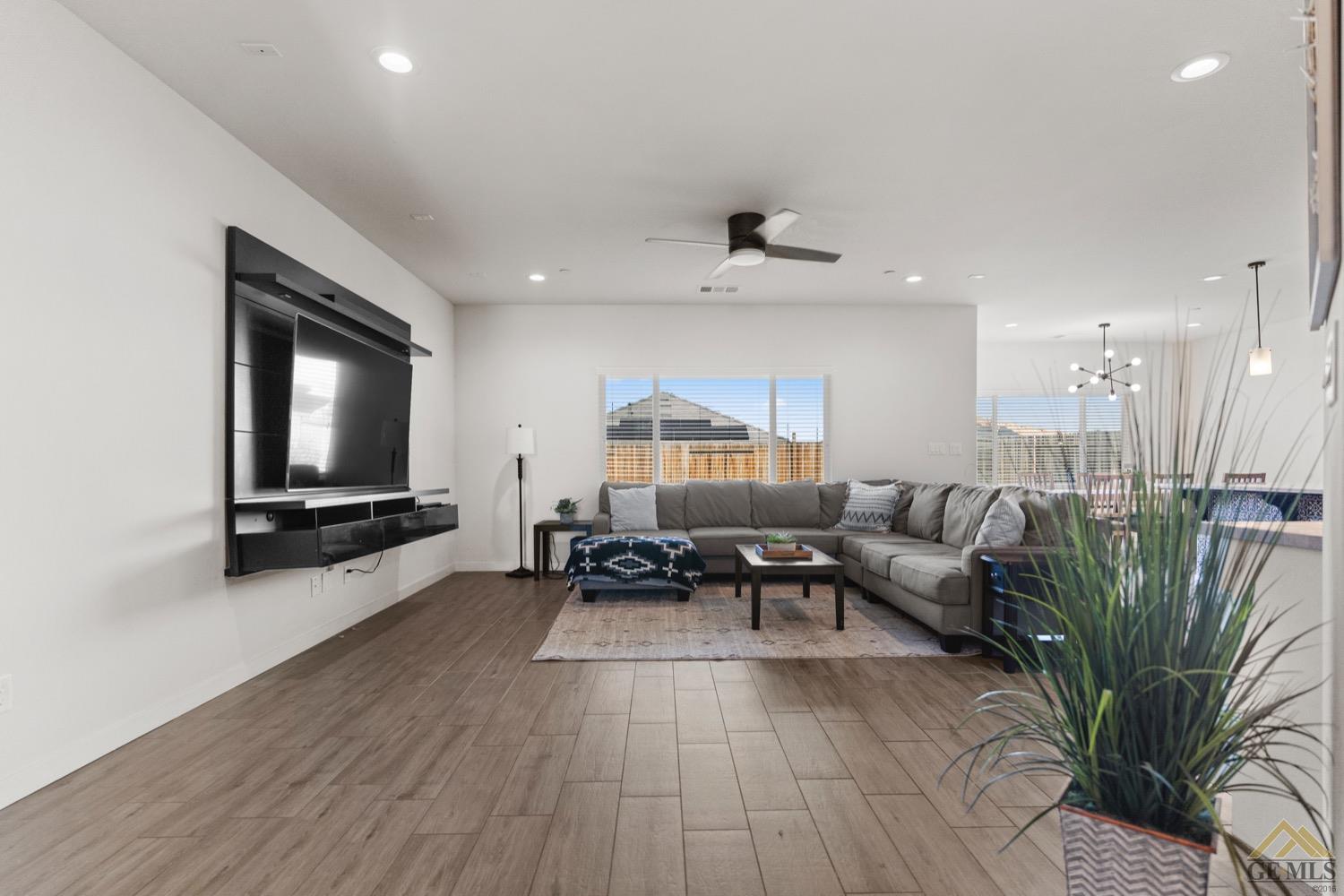 Undisclosed Address Bakersfield, CA 93314 - Photo 6 of 44 a living room with furniture and a flat screen tv