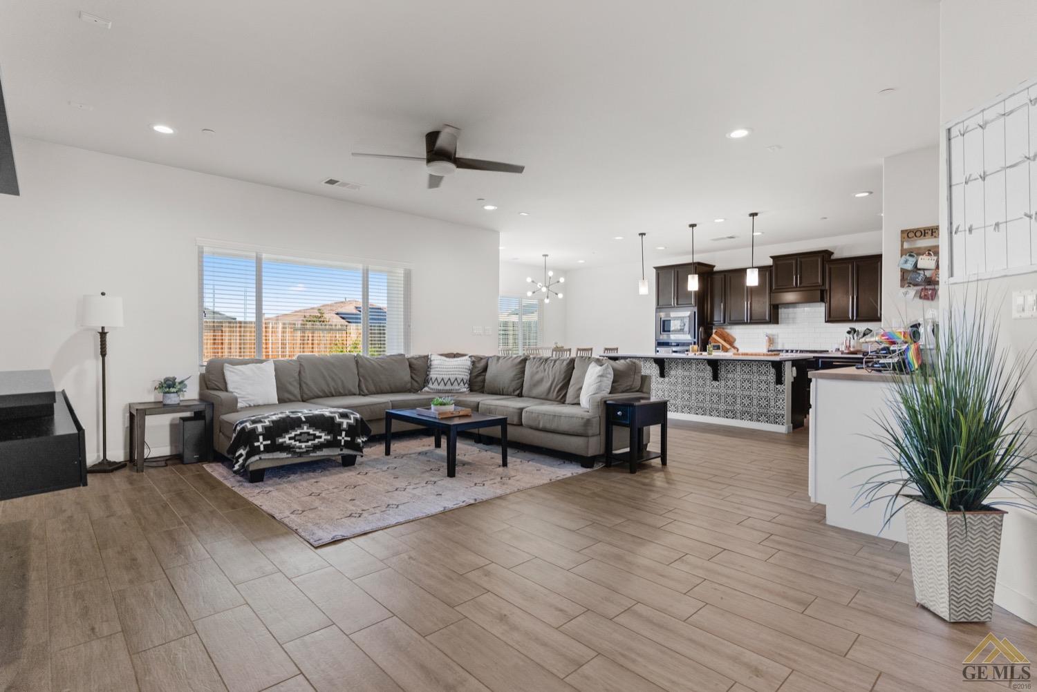 Undisclosed Address Bakersfield, CA 93314 - Photo 7 of 44 a living room with furniture and a dining table with wooden floor