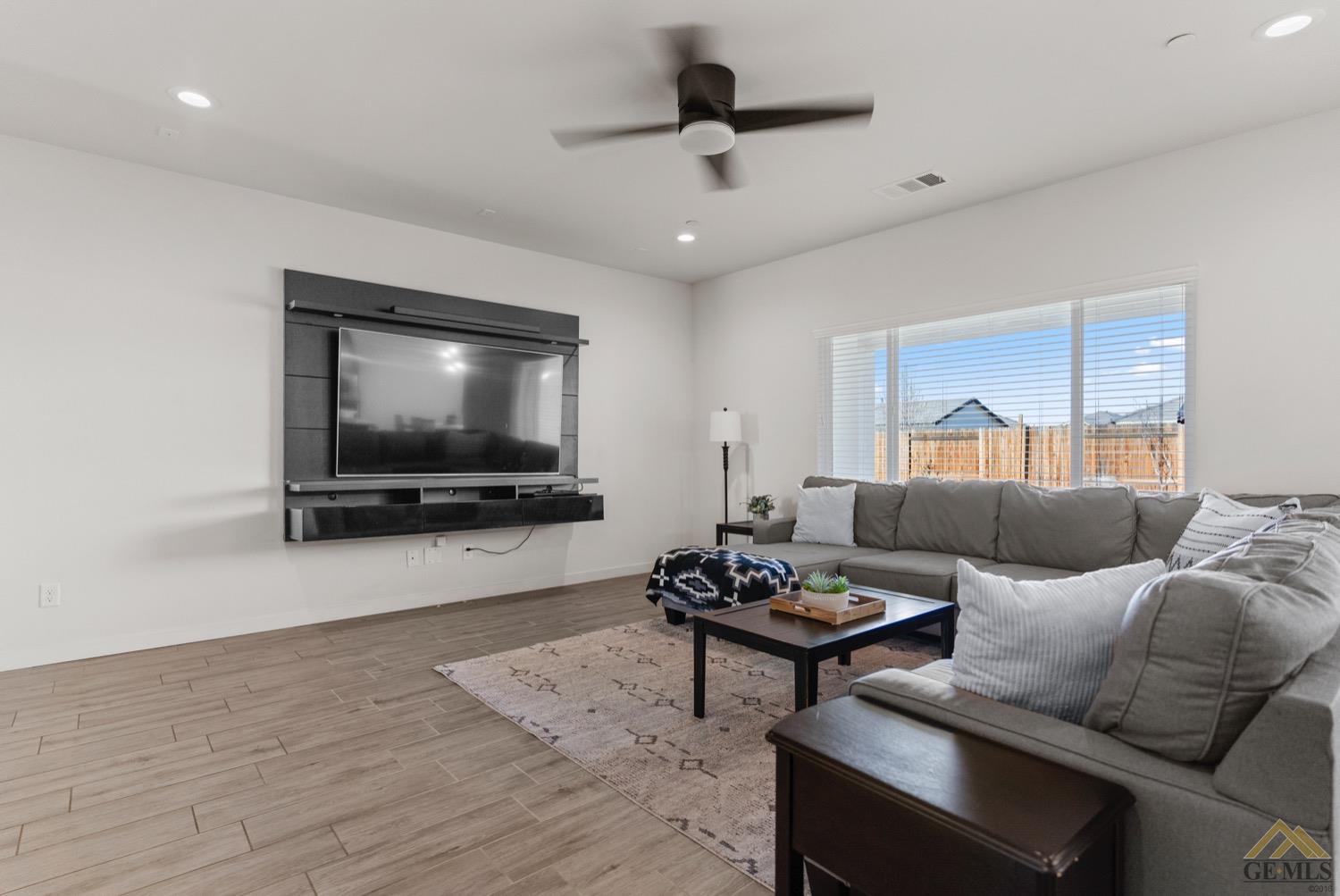 Undisclosed Address Bakersfield, CA 93314 - Photo 8 of 44 a living room with furniture and a flat screen tv