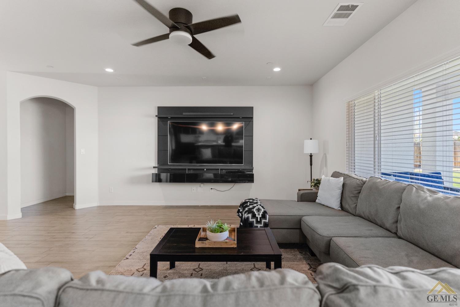 Undisclosed Address Bakersfield, CA 93314 - Photo 9 of 44 a living room with furniture and a flat screen tv