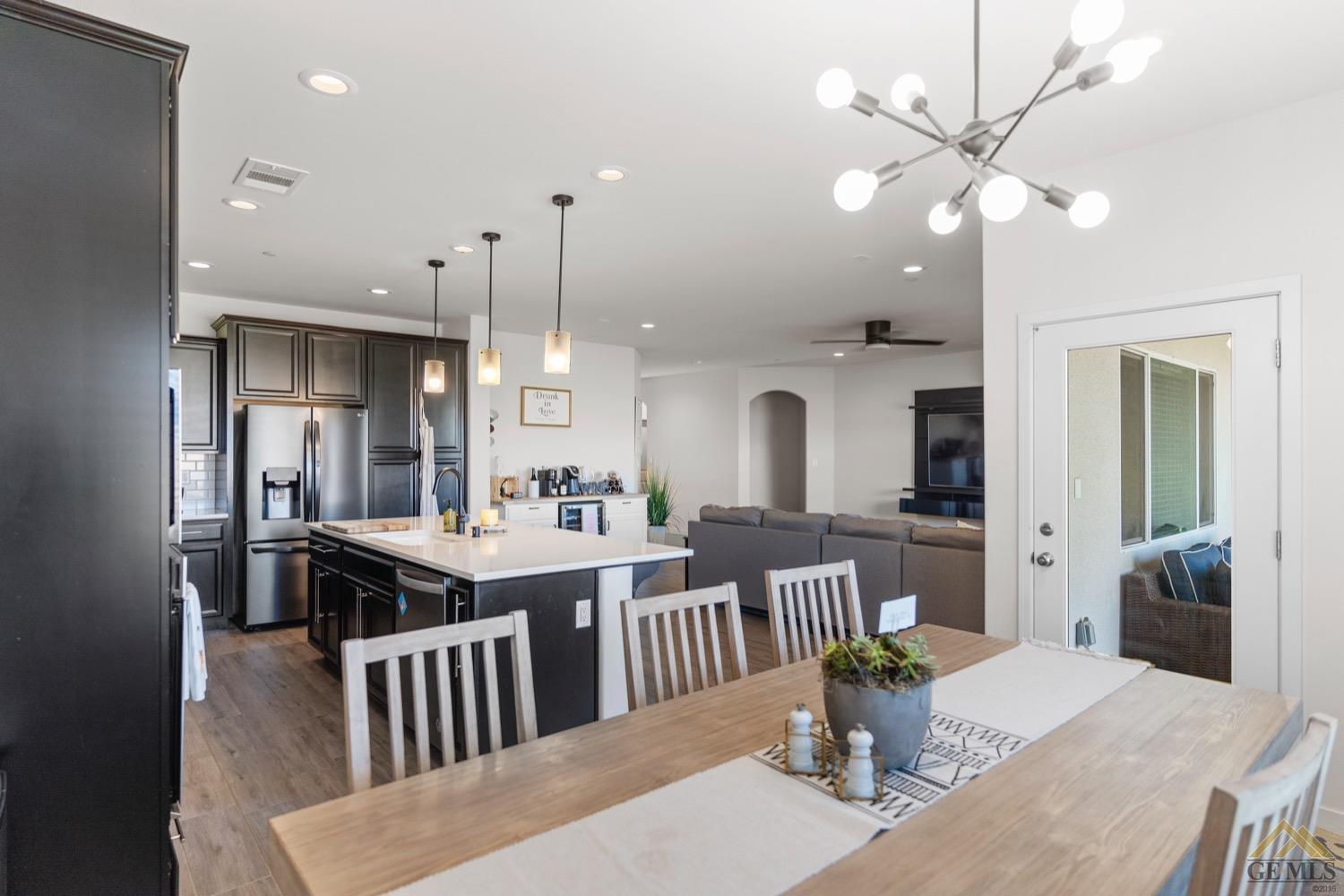 Undisclosed Address Bakersfield, CA 93314 - Photo 10 of 44 a kitchen with a table and chairs