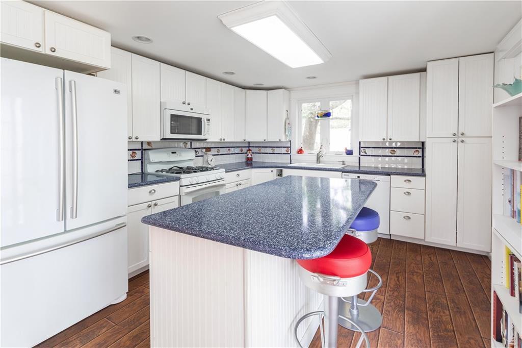 60 Lowells Cove Road Orrs Island, ME 04066 - Photo 10 of 27 A bright white kitchen with colorful...