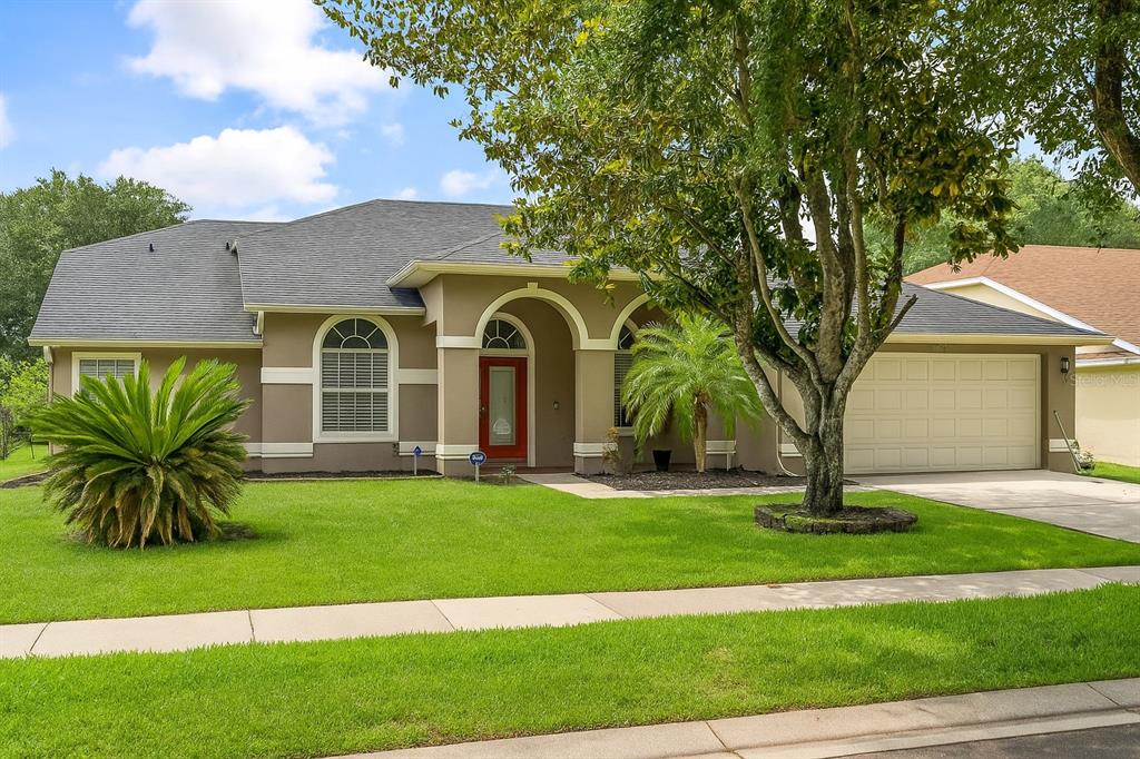 8202 Windsor Ridge Road Orlando, FL 32835 - Photo 1 of 1 a front view of a house with a yard and garage