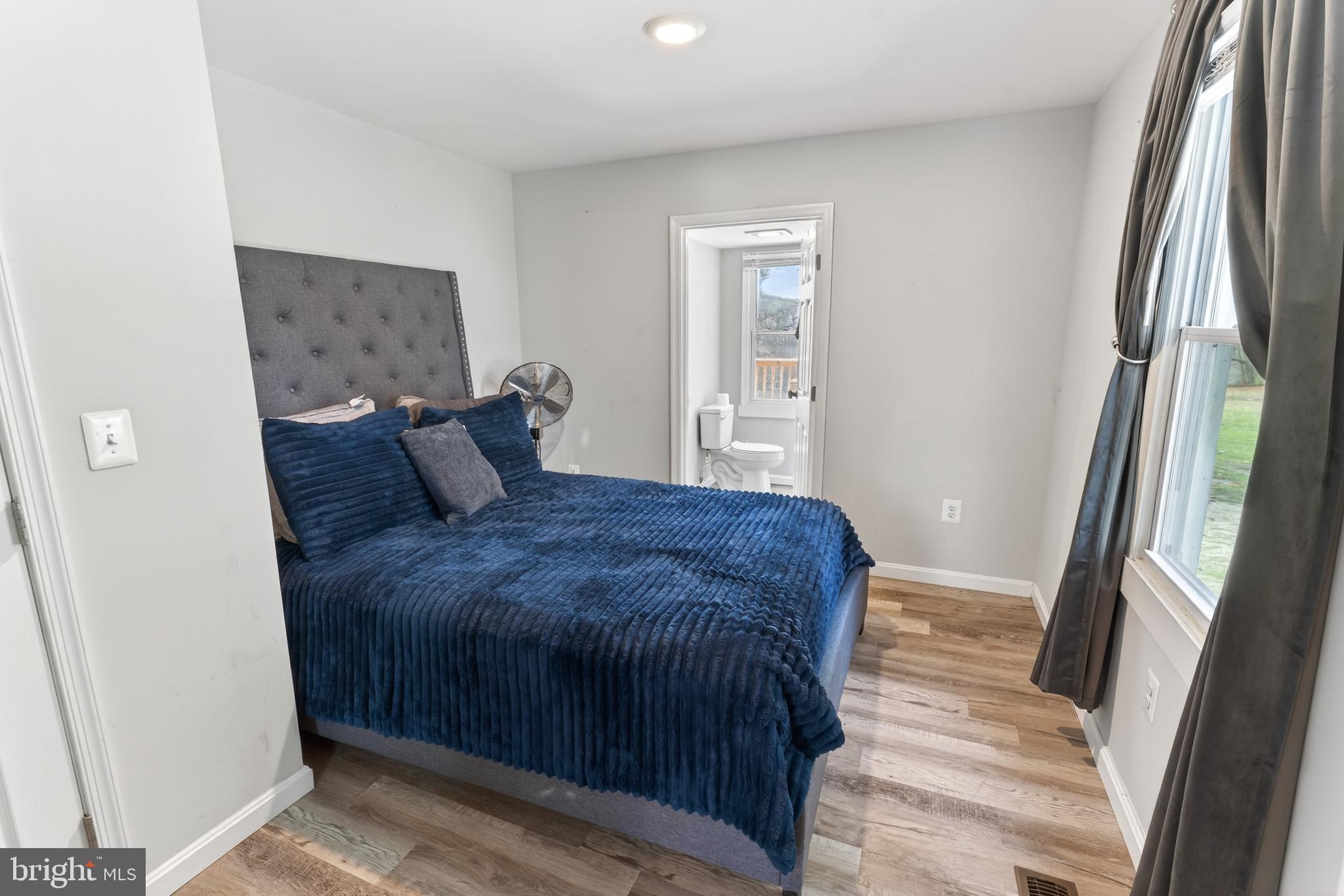 1002 West Main Street Salisbury, MD 21801 - Photo 11 of 31 a bedroom with a bed and a mirror