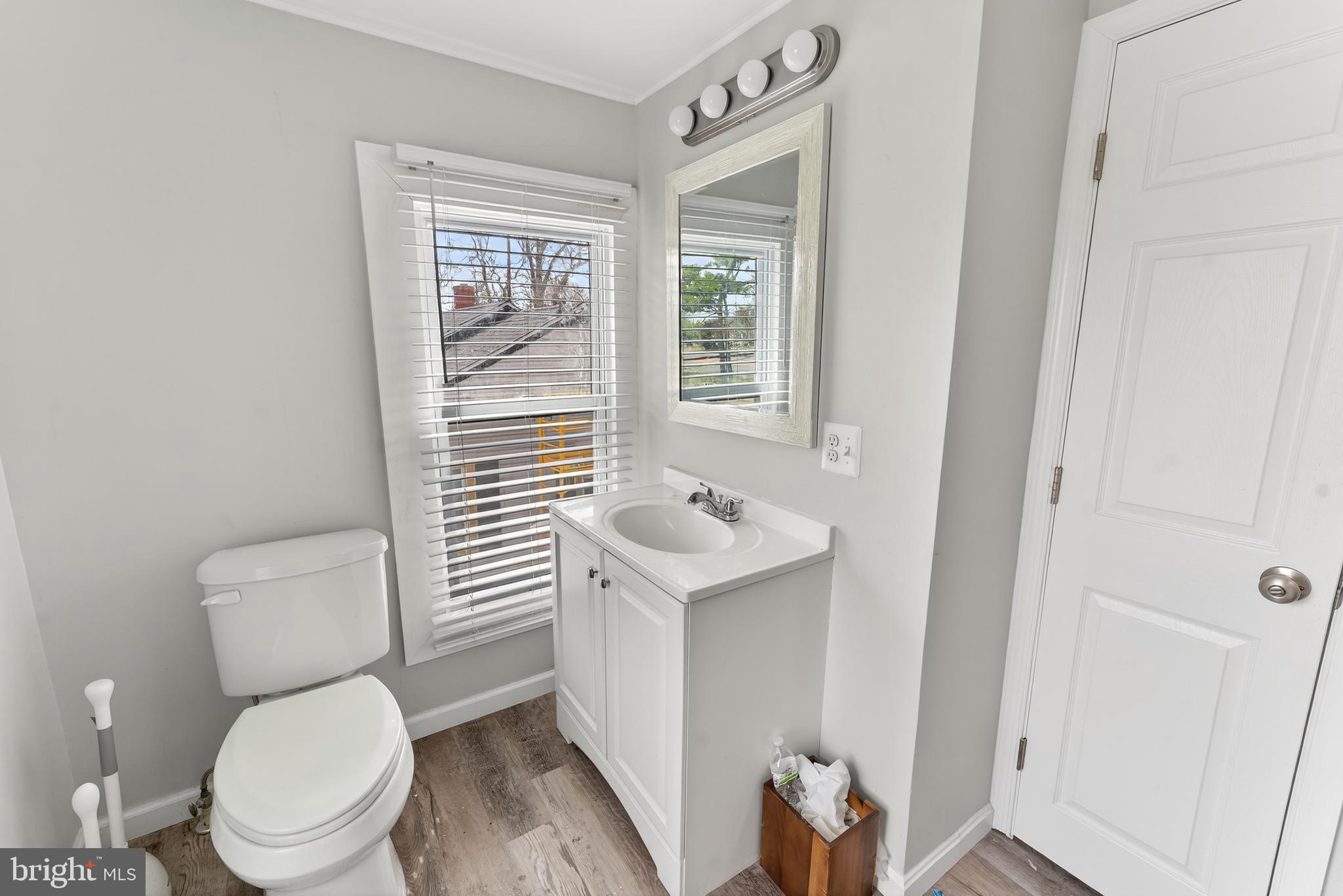 1002 West Main Street Salisbury, MD 21801 - Photo 28 of 31 a white toilet sitting next to a bathroom sink