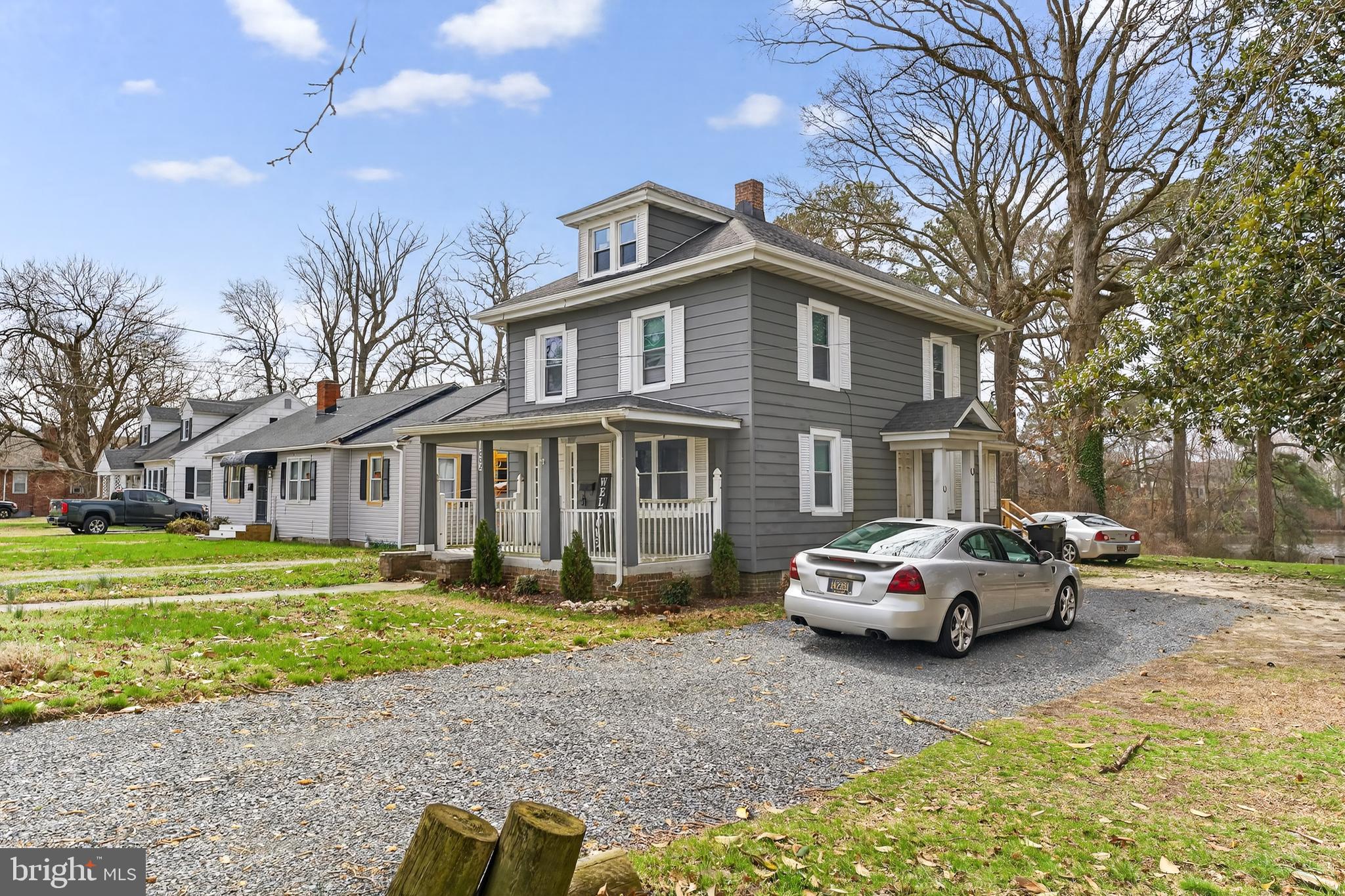 1002 West Main Street Salisbury, MD 21801 - Photo 4 of 31 a front view of a house with a garden and trees