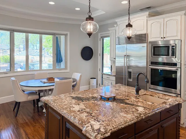 a dining room with furniture and wooden floor