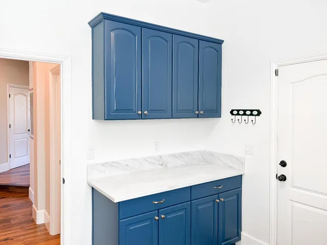a view of a hallway to a livingroom with furniture