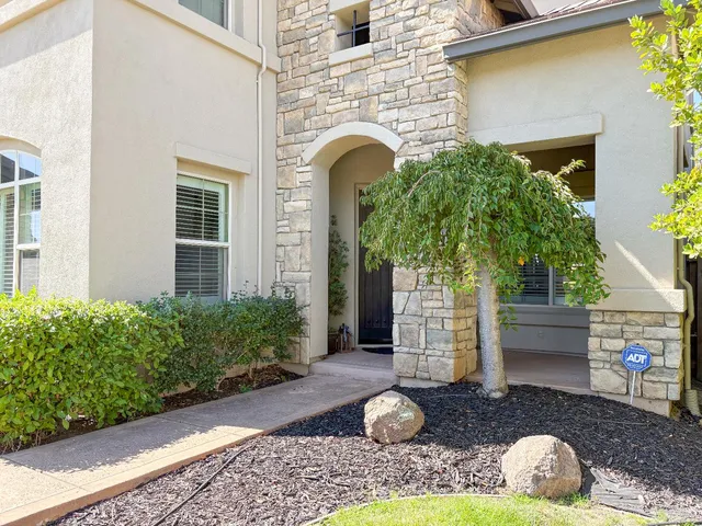 a front view of a house with garden
