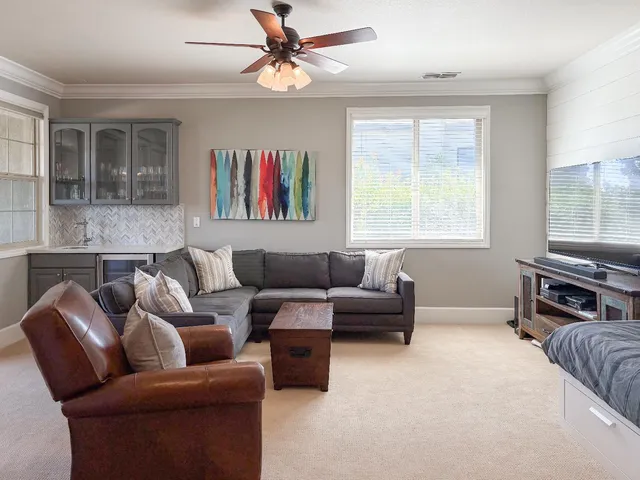 a view of a house with swimming pool and a chairs in patio