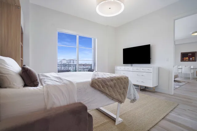 a bedroom with a bed and a flat screen tv