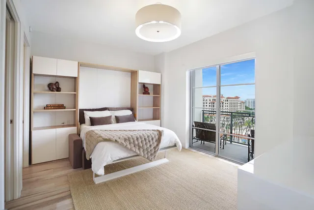 a bedroom with a large bed and a chandelier