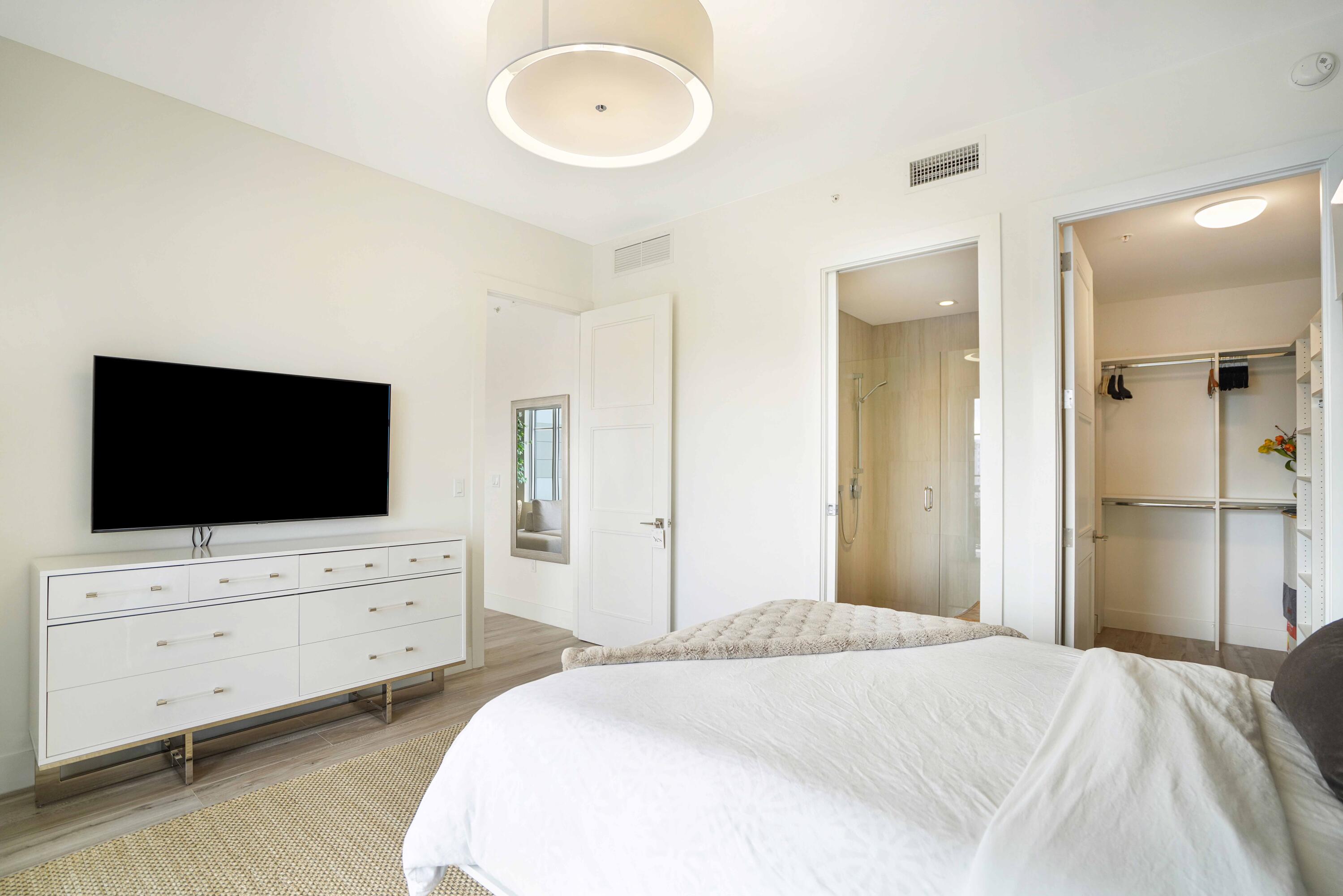 155 East Boca Raton Road, Unit 912 Boca Raton, FL 33432 - Photo 18 of 56 a bedroom with bed and flat screen tv