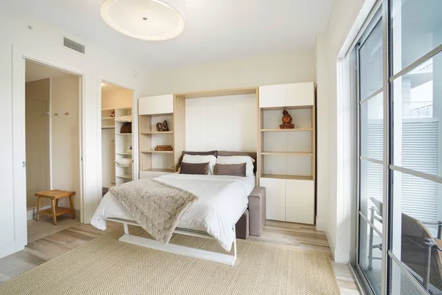 a bedroom with a bed and a cabinets