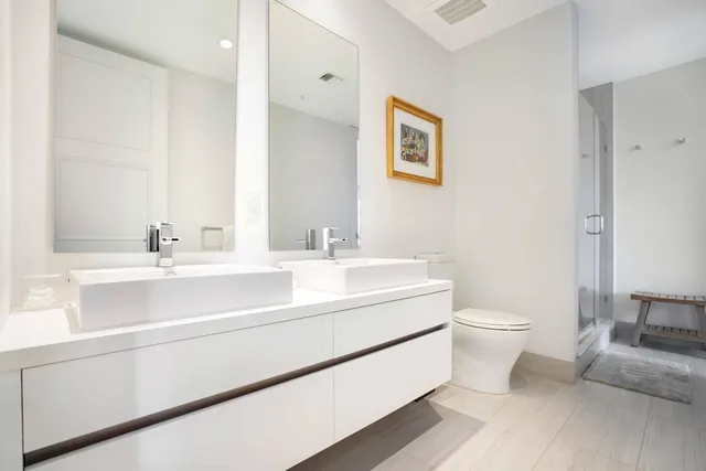 a bathroom with a sink mirror vanity and toilet
