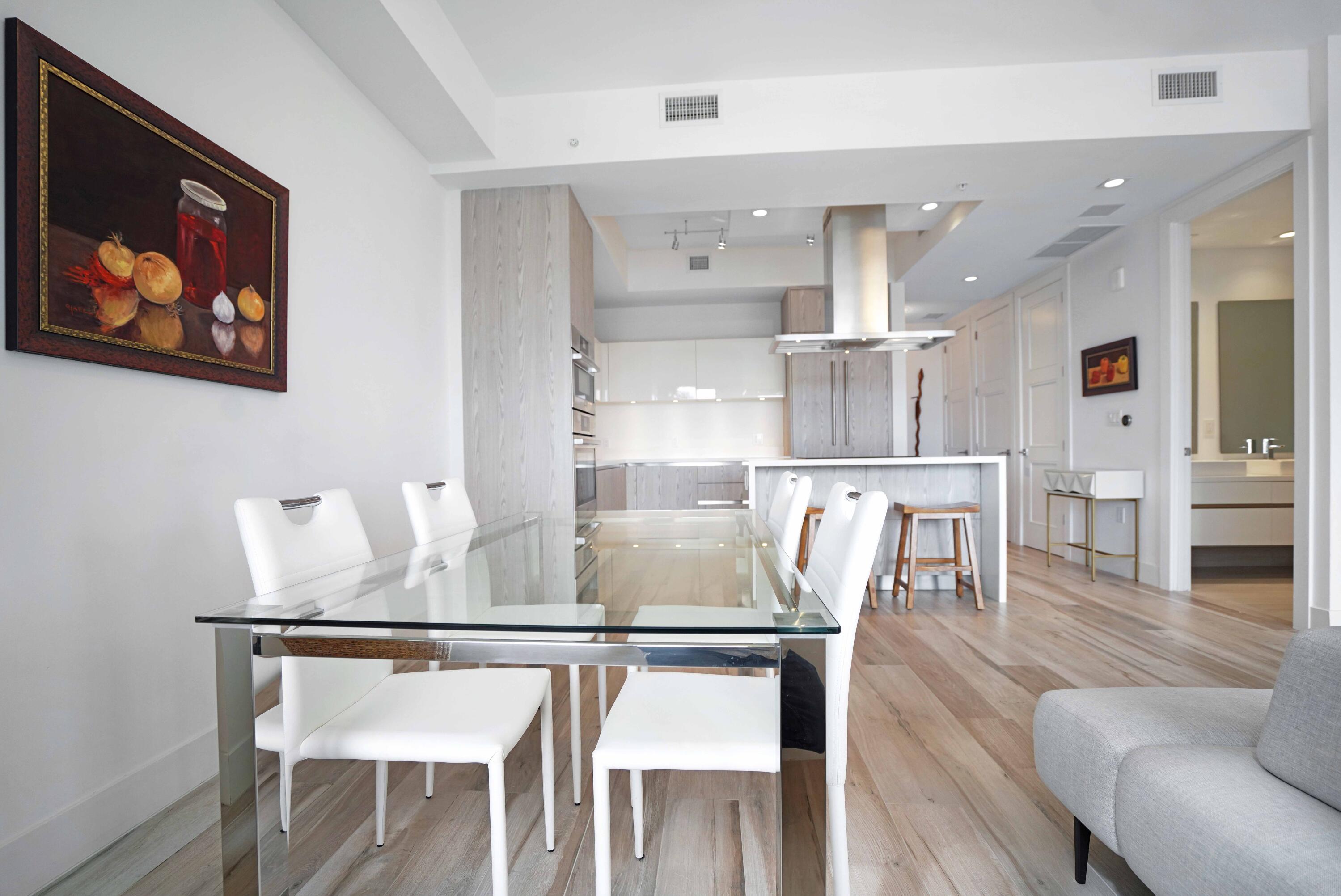 155 East Boca Raton Road, Unit 912 Boca Raton, FL 33432 - Photo 22 of 56 a kitchen with stainless steel appliances granite countertop a dining table chairs and view of living room