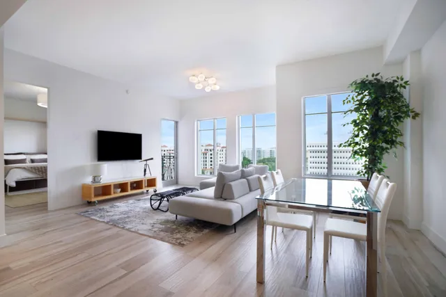 a living room with furniture wooden floor and a flat screen tv