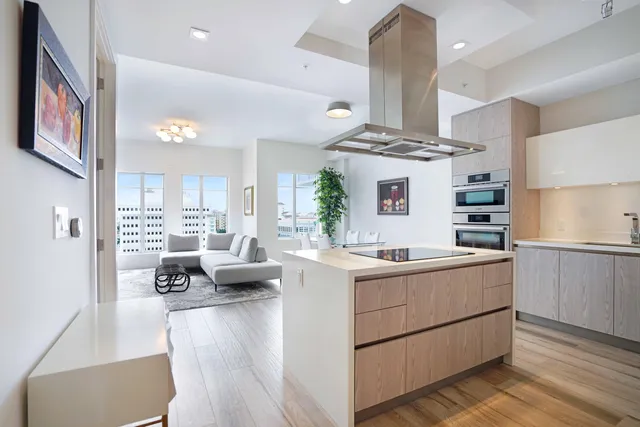 a kitchen with stainless steel appliances kitchen island granite countertop a stove and cabinets