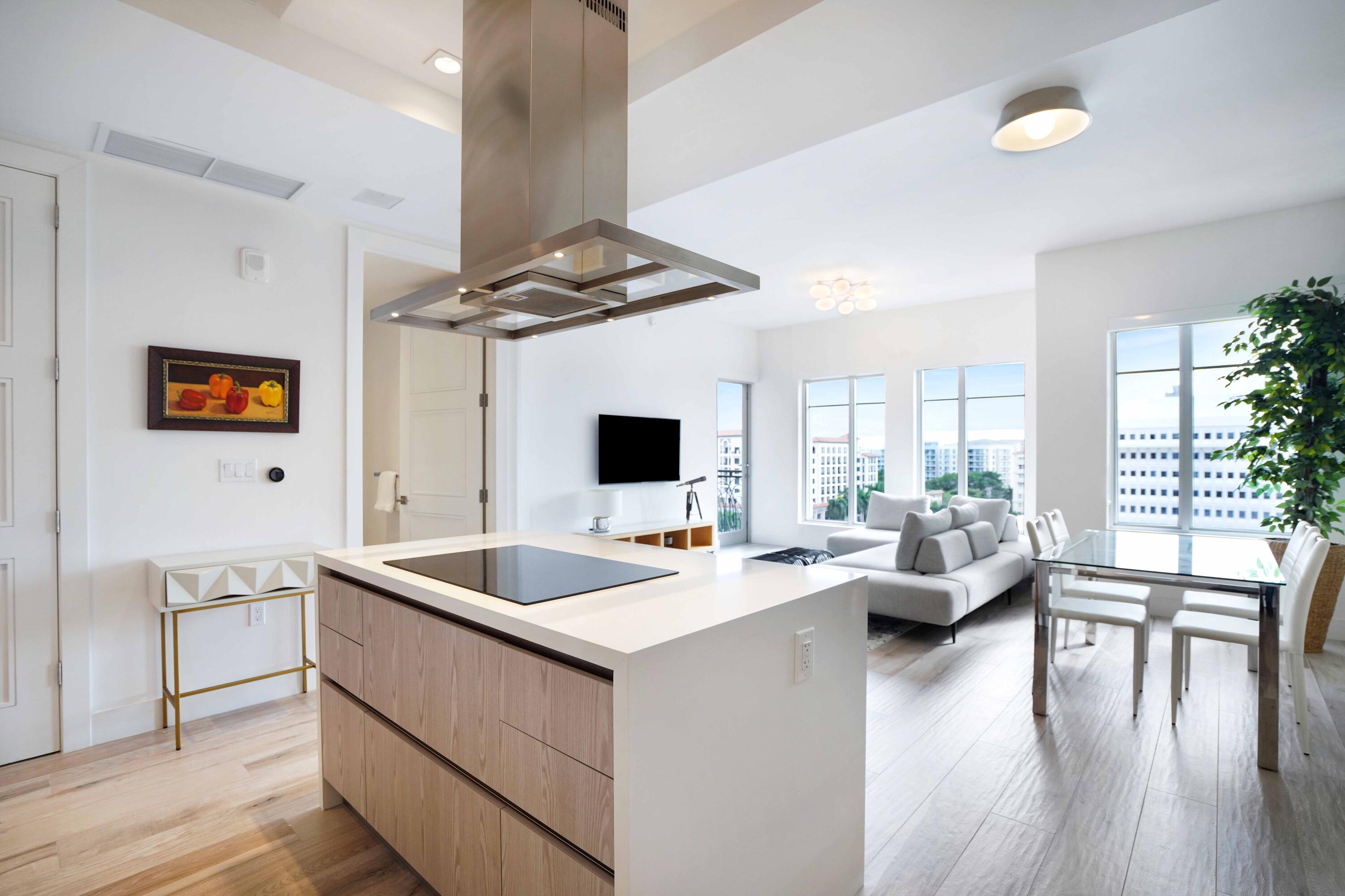 155 East Boca Raton Road, Unit 912 Boca Raton, FL 33432 - Photo 8 of 56 a living room with stainless steel appliances kitchen island furniture and a wooden floor